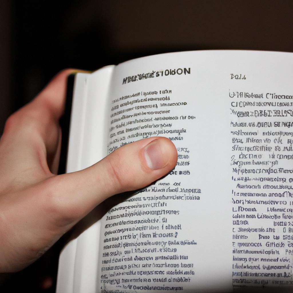 Person holding French dictionary, studying