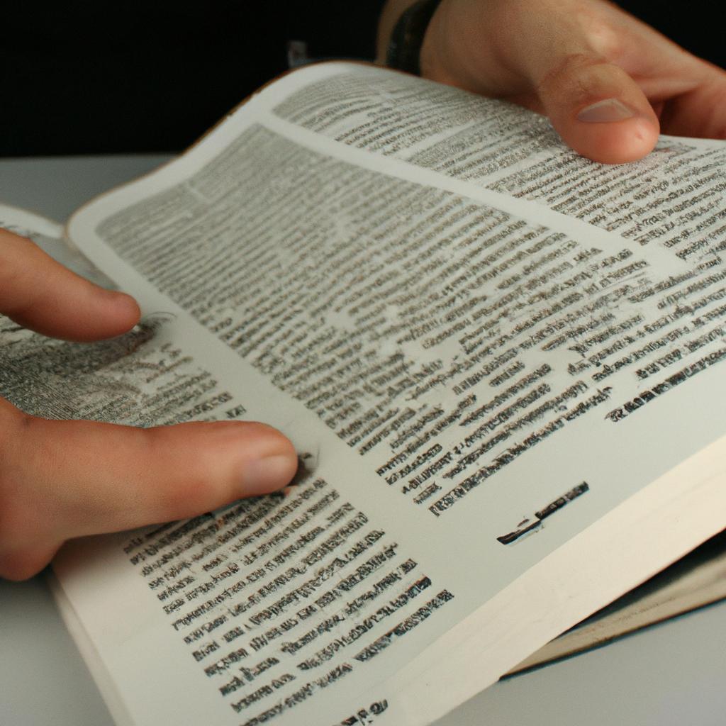 Person reading technical dictionaries, writing